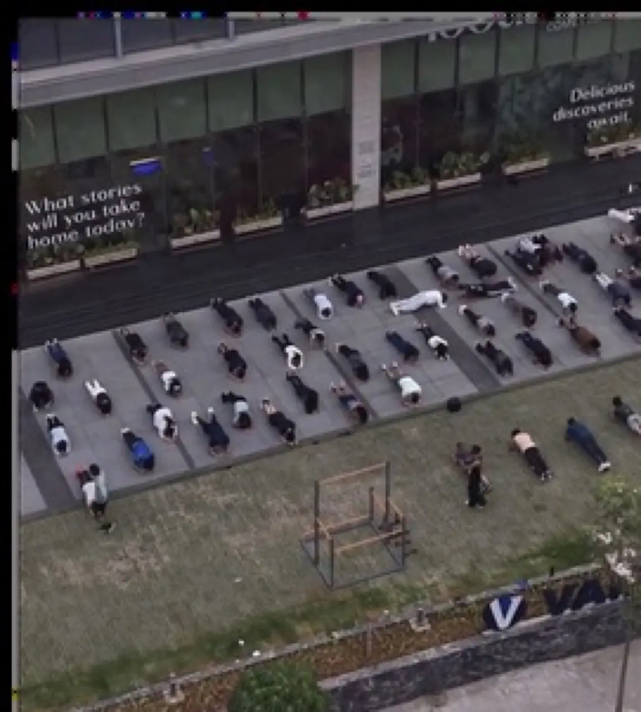 Aerial view of a large group doing a bodyweight workout together in rows