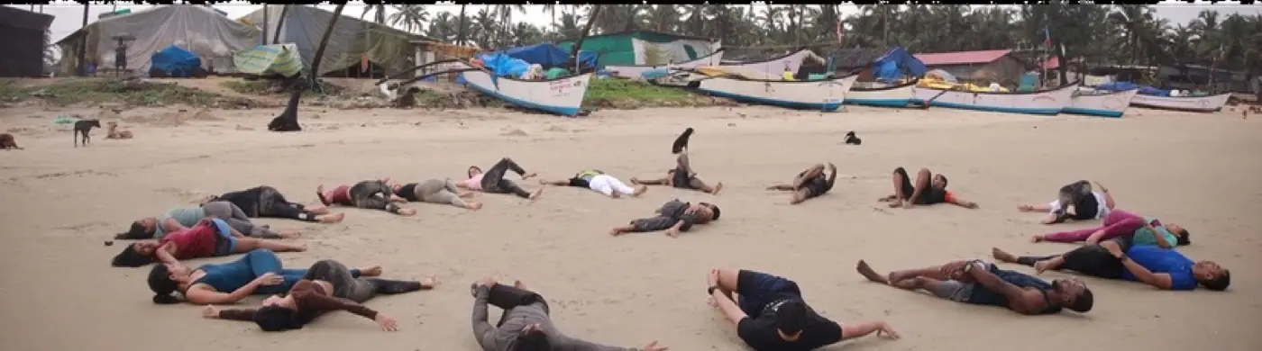 Group resting on the beach after a morning session